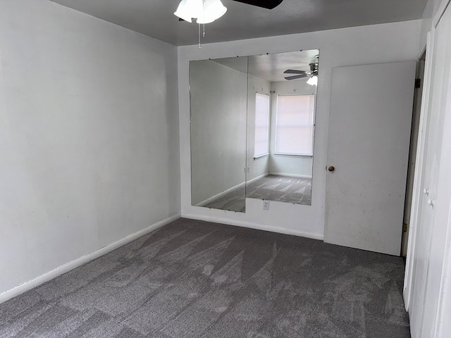 interior space with baseboards and a ceiling fan