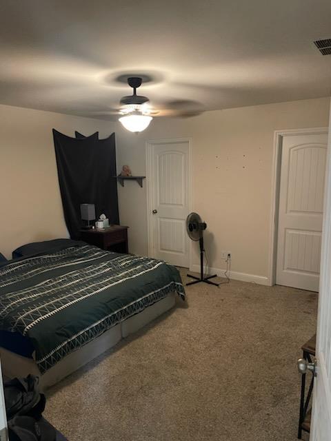 carpeted bedroom featuring ceiling fan