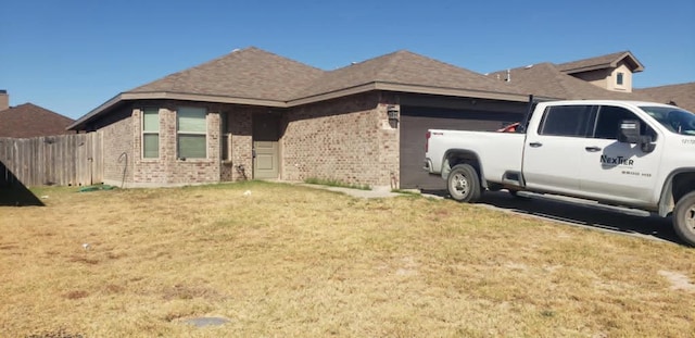 view of side of property with a lawn and a garage