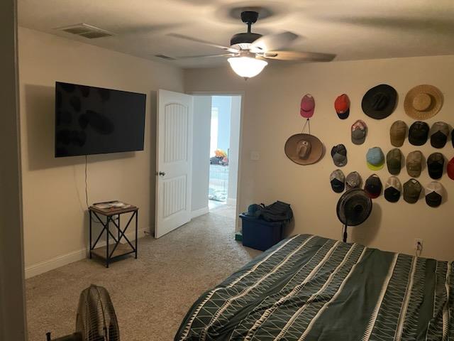 carpeted bedroom with ceiling fan