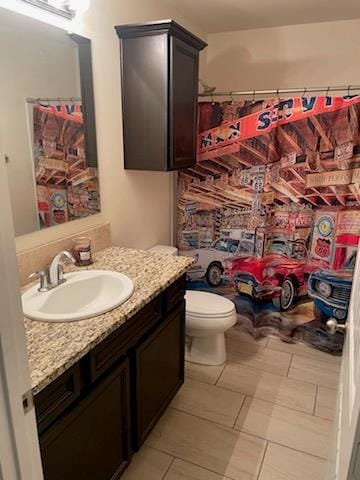 bathroom with toilet, vanity, tile patterned floors, and a shower with shower curtain