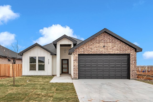 view of front of house with a garage and a front yard