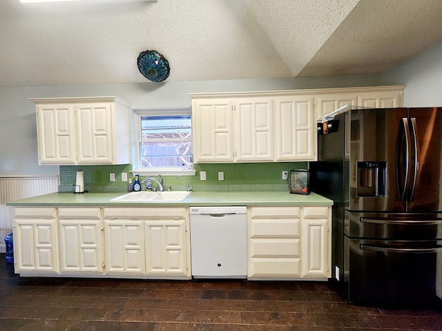 kitchen featuring dark wood finished floors, dishwasher, stainless steel fridge with ice dispenser, vaulted ceiling, and a sink