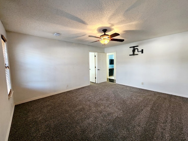 unfurnished room with baseboards, visible vents, a ceiling fan, a textured ceiling, and carpet floors