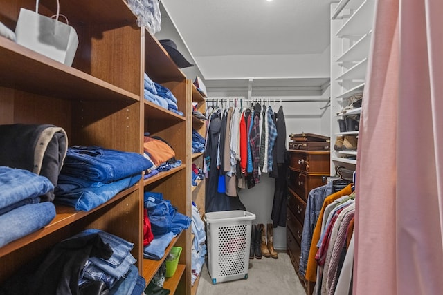 walk in closet featuring light carpet