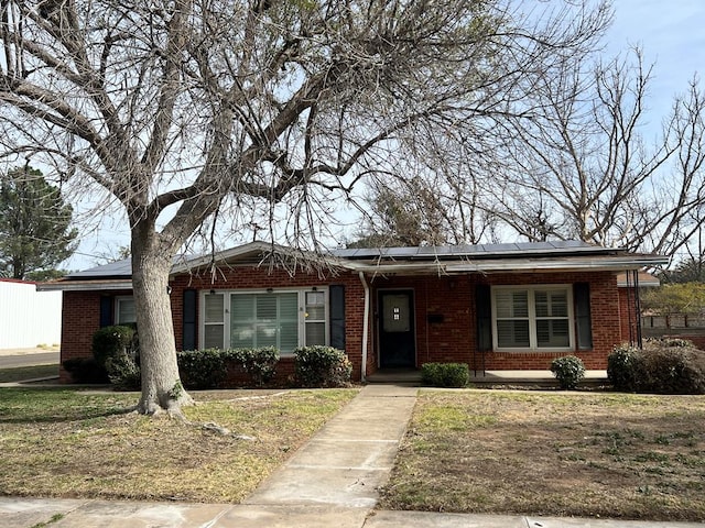 view of front of property featuring solar panels