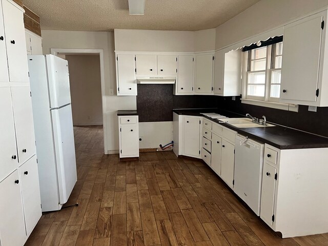 kitchen with white cabinetry, sink, dark hardwood / wood-style floors, and white appliances