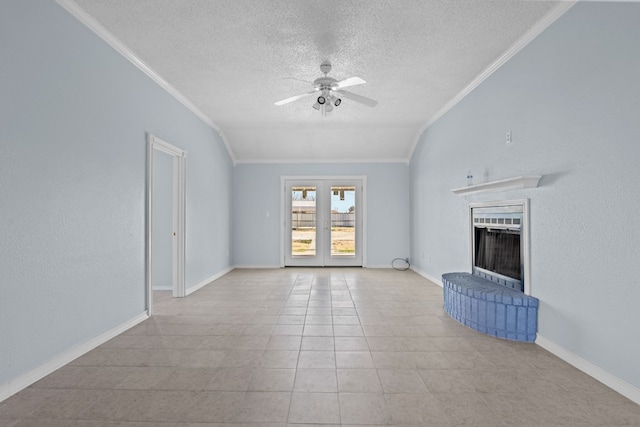 unfurnished living room with a textured ceiling, a fireplace, ornamental molding, and ceiling fan