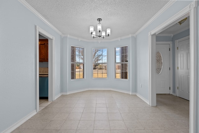 empty room with an inviting chandelier, ornamental molding, a textured ceiling, and light tile patterned flooring