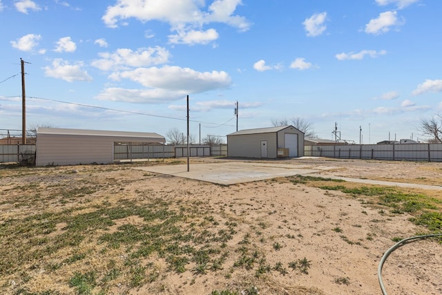 view of yard with a garage and an outdoor structure