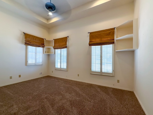 spare room with ceiling fan and carpet