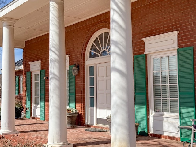 view of exterior entry featuring a porch