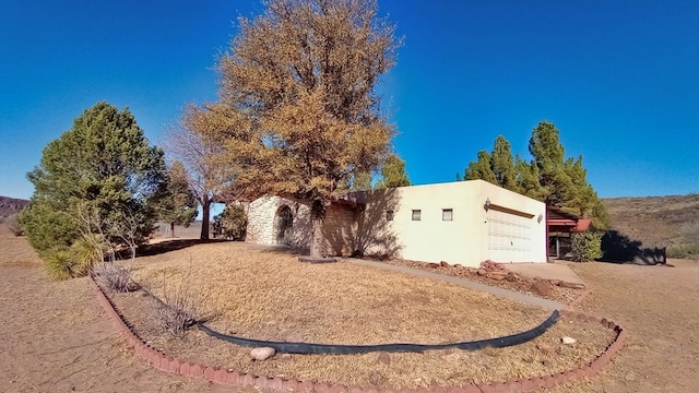 view of front of home featuring an attached garage and stucco siding