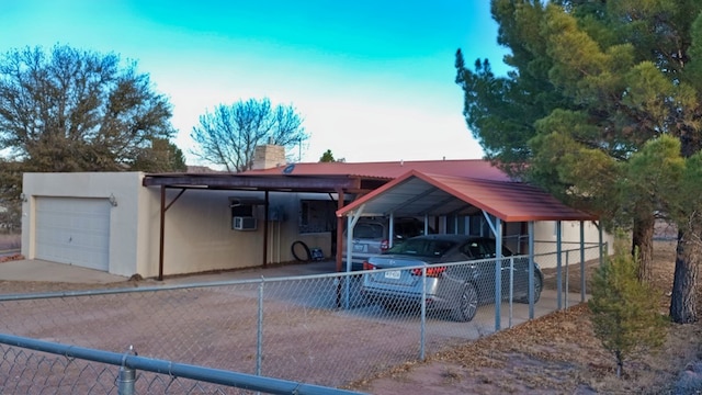 view of front of house featuring a garage, a chimney, fence, and stucco siding