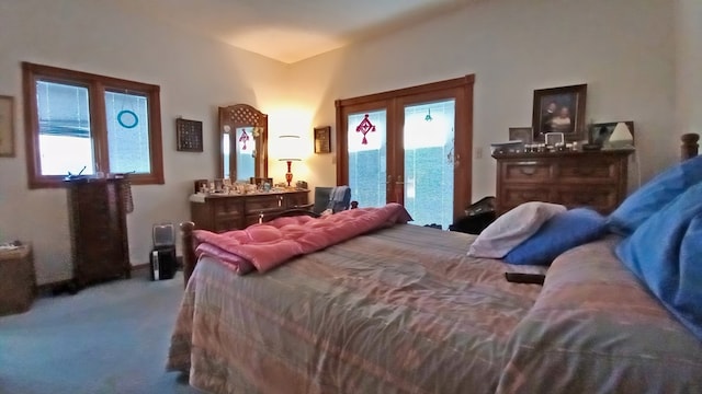 bedroom with carpet floors, access to outside, french doors, and multiple windows