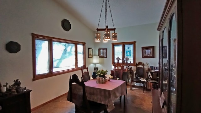 dining space featuring lofted ceiling and a chandelier