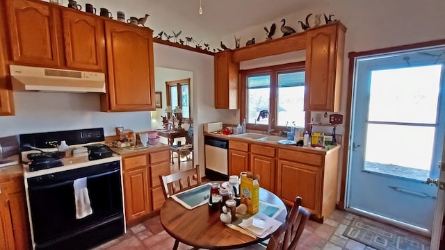 kitchen with dishwashing machine, black range with gas stovetop, light countertops, under cabinet range hood, and a sink