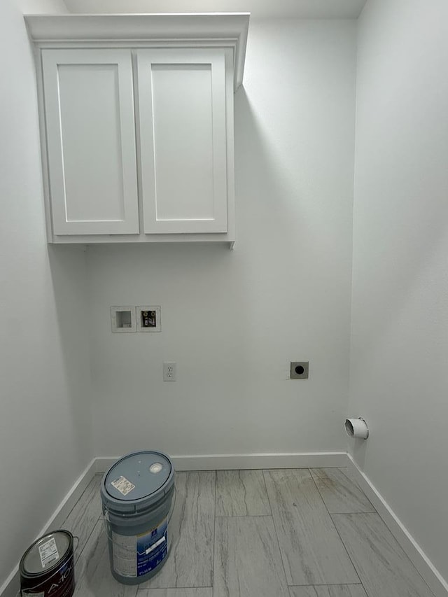 washroom featuring washer hookup, cabinets, and hookup for an electric dryer