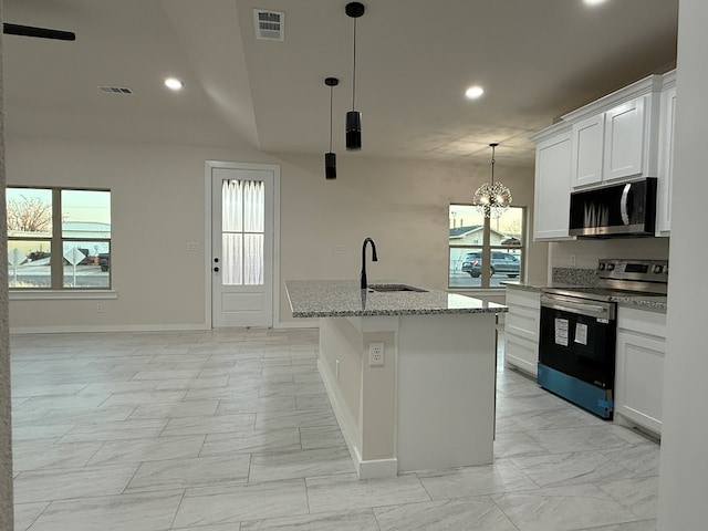 kitchen with stainless steel appliances, a kitchen island with sink, sink, and white cabinets