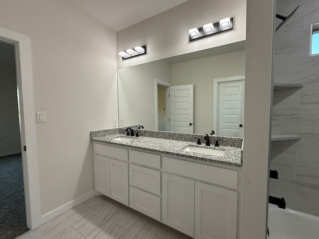 bathroom with tiled shower and vanity