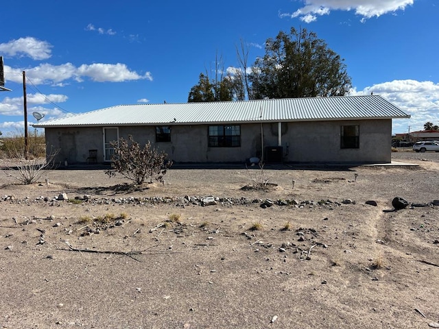 rear view of property with cooling unit