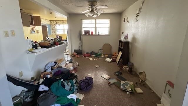 miscellaneous room featuring a textured ceiling and ceiling fan