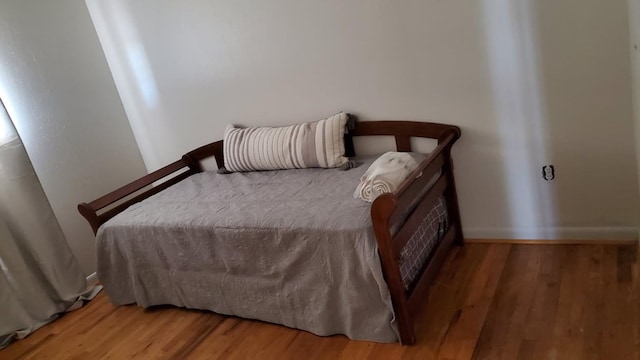 bedroom with wood-type flooring