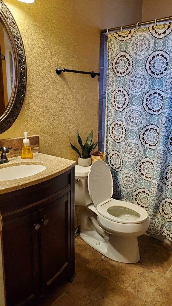 bathroom featuring vanity and toilet