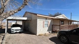 view of side of home with a carport