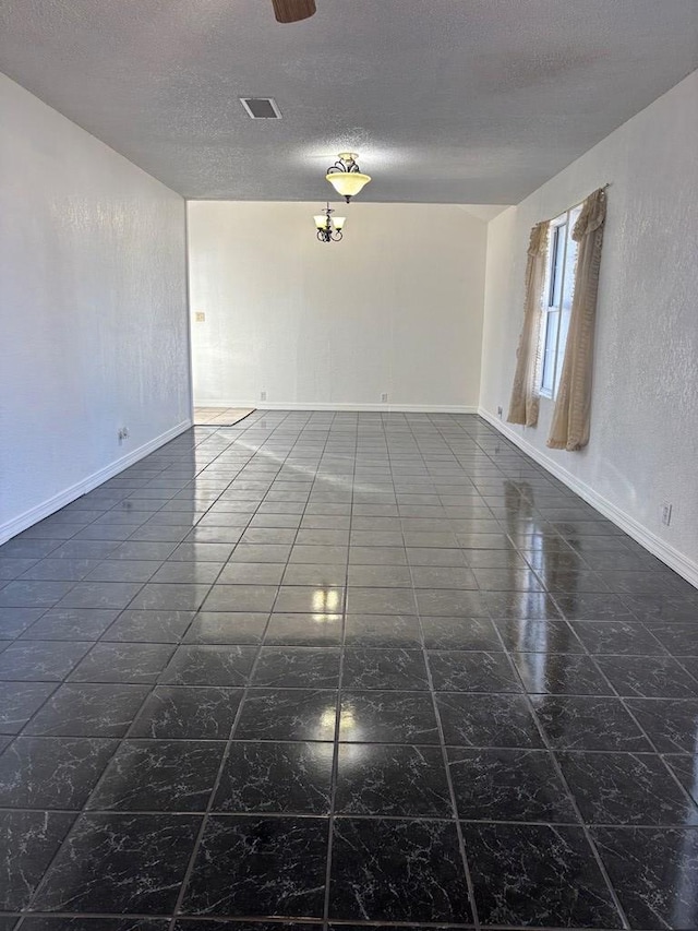 spare room with a textured ceiling