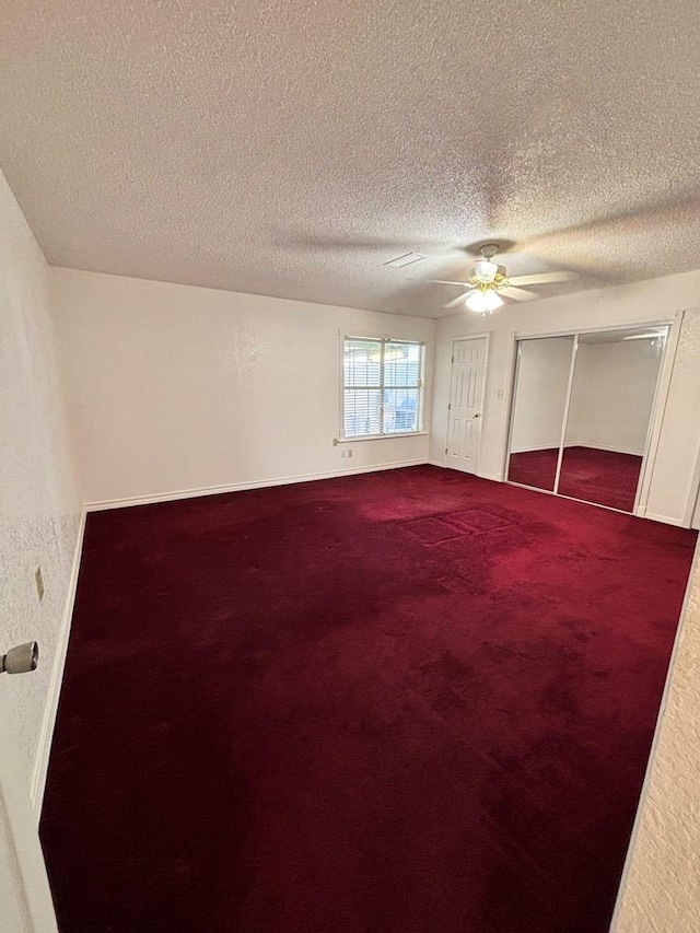 unfurnished bedroom with carpet, a textured ceiling, a closet, and ceiling fan