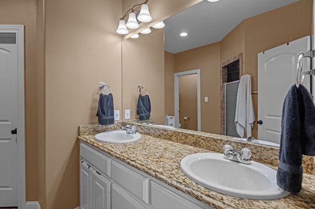 bathroom featuring a shower with door, vanity, and toilet