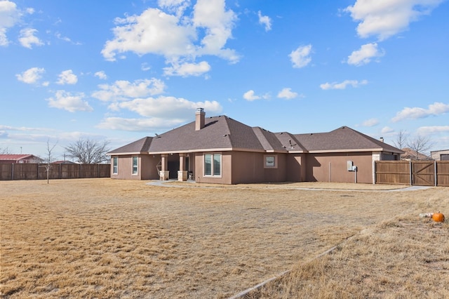 rear view of property featuring a patio area