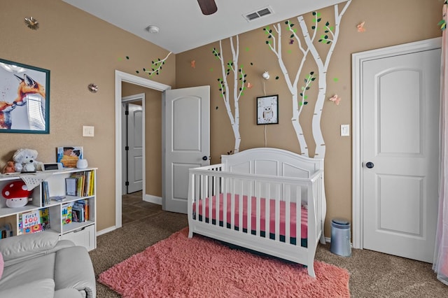 bedroom with a crib and carpet