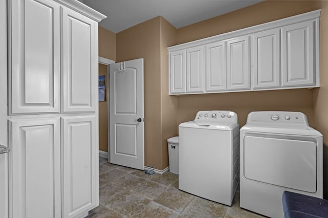 washroom featuring cabinets and washing machine and dryer