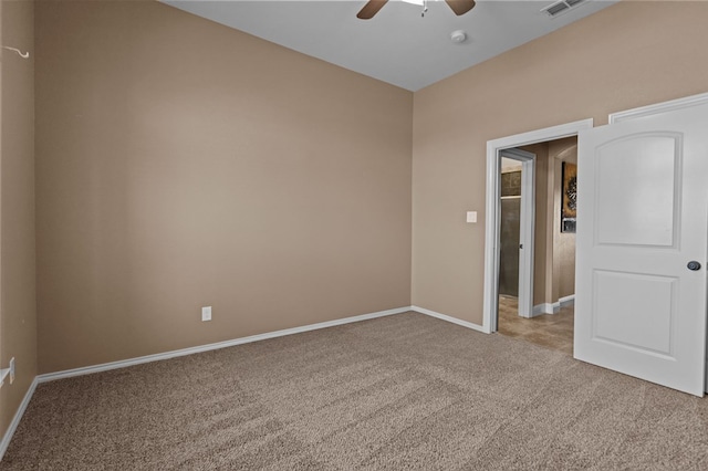 carpeted spare room with ceiling fan