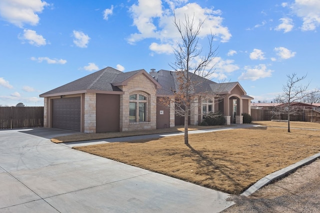 ranch-style house featuring a garage and a front lawn