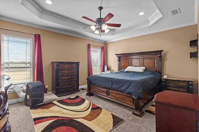 bedroom featuring light carpet, ornamental molding, and a raised ceiling