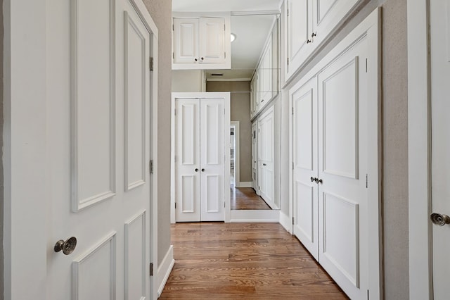 corridor with hardwood / wood-style floors