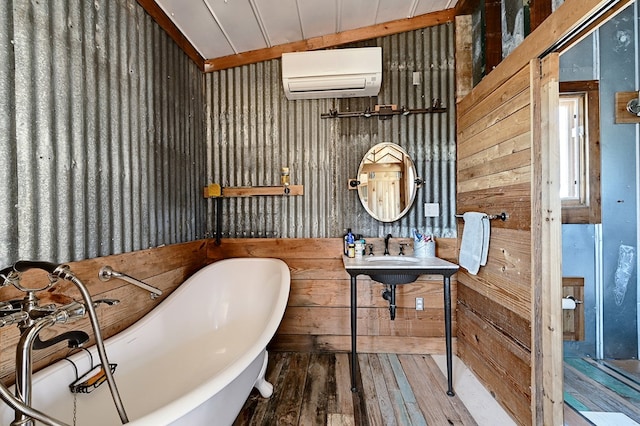 bathroom featuring a wall mounted air conditioner, hardwood / wood-style floors, wood walls, lofted ceiling, and a tub to relax in