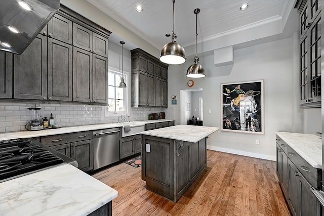 kitchen with crown molding, exhaust hood, dishwasher, light hardwood / wood-style floors, and a kitchen island