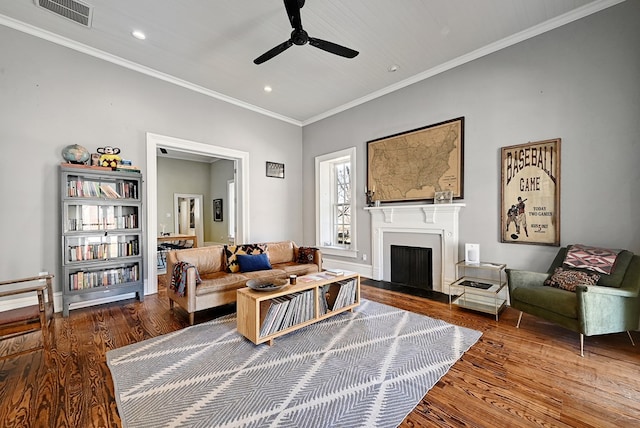 living room with ceiling fan, hardwood / wood-style floors, and crown molding