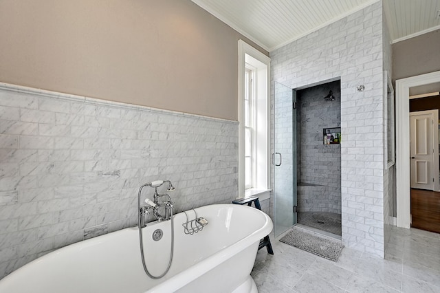 bathroom featuring crown molding, plenty of natural light, tile walls, and shower with separate bathtub