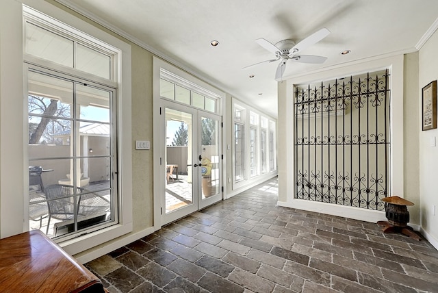 entryway featuring french doors, ceiling fan, and ornamental molding