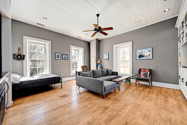 living room featuring ceiling fan, light hardwood / wood-style floors, and a wealth of natural light