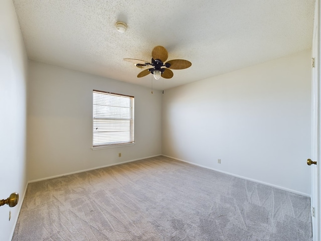 empty room with a textured ceiling and light carpet