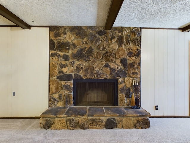 details with wood walls, a fireplace, carpet, and a textured ceiling