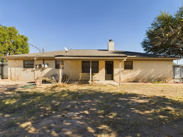 rear view of property with a yard