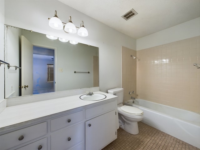 full bathroom with tile patterned flooring, a textured ceiling, toilet, vanity, and tiled shower / bath