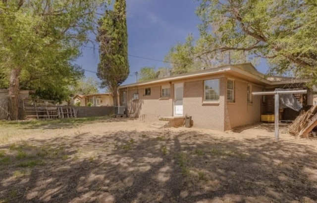 rear view of house with fence